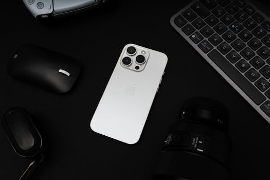 Home A sleek flat lay of modern tech gadgets with a smartphone and accessories on a dark background.