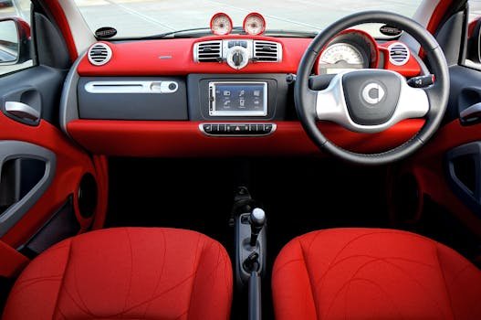 Home Explore the sleek design and vibrant red tones in this modern car interior shot.